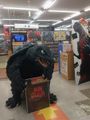 A statue of the 1995 Gamera suit holding an advertisement for Shin Godzilla