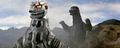 Mechagodzilla rotates its head to attack King Caesar, who is approaching it from behind