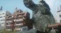 Gamera uses a Hard Slap to destroy a building in his way
