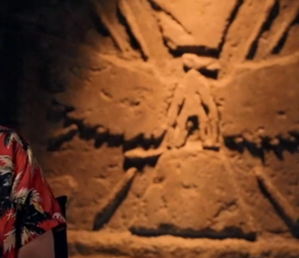 A wall carving depicting Phosphera, as seen in the background of an interview with Dan Stevens for Godzilla x Kong: The New Empire