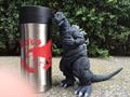 Insulated Godzilla 2016 mug from the September 6 shoot alongside a NECA Godzilla 1954 figure