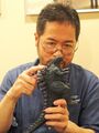 Fuyuki Shinada holding a figure of Godzilla Earth