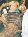 Rie Ota peers out of a Baragon suit during filming of GMK