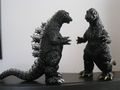Glossy black Godzilla 1964 (left) and glossy "gold spray" Godzilla 1964 (right)