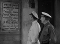 Carl Denham and Captain Englehorn observing the poster advertising The Musical Monkeys.