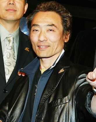 Godzilla suit actor Tsutomu Kitagawa arrives at the premiere of "Godzilla Final Wars" at the Chinese Theatre on November 29, 2004 in Los Angeles, California.