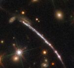 The Sunburst galaxy. Godzilla is the bright spot in the center of the galaxy directly above the closer orange star