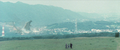 Kenta, his grandfather Samon and Minilla watch Godzilla attacking the city