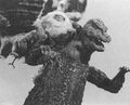 The small Mothra imago puppet fighting a Godzilla hand puppet in a deleted shot from the film