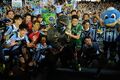 Godzilla with Kawasaki Frontale players at a J.League match at Todoroki Stadium