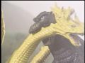 Godzilla biting one of King Ghidorah's necks
