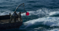 Hidetaka Yoshioka and Yuki Yamada dropping a buoy into the sea