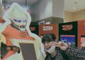 Megumi Odaka with a Jet Jaguar standee