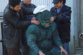 Kenji Oka trying on the Gaira suit with assistance from members of the staff