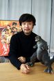 Takahashi Yamazaki with the statue of Third Street Godzilla