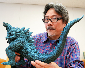 Yuji Sakai holding the Banpresto Anime Godzilla vinyl figure