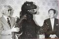 Tanaka (right) with Ishiro Honda and a Godzilla attraction suit