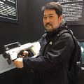 Director Hiroyuki Seshita holding an Infantry-Employed Electromagnetic Induction Rifle
