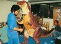 Fuyuki Shinada (left) oversees a test fitting of the Godzillasaurus suit