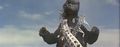 Godzilla tests his magnetic abilities by drawing two electrical towers toward and onto him