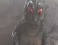 LittleGodzilla's eyes glowing red after SpaceGodzilla notices him