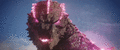 Godzilla fires his magenta atomic breath at Kong