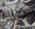 A close-up of the Godzilla Head looking down on Tokyo