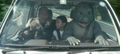 Minilla sits in the passenger seat with Kenta and Samon Taguchi