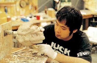 Shigeaki Ito sculpting the Kamoebas miniature for Godzilla: Tokyo SOS