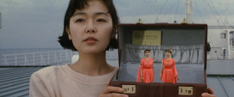 Masako holding the Cosmos in Godzilla vs. Mothra